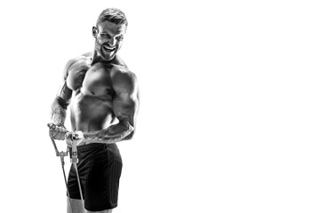 Handsome muscular strong man doing pulling exercise and working hard.