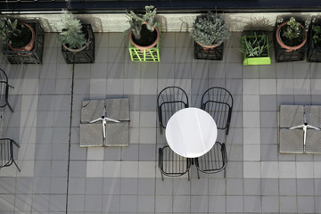 Top view of a metal table with chairs in a hotel terrace.
