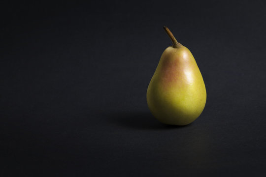 Reddish pear on a dark gray background