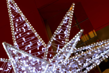 Close-up of piece of Christmas star decoration, blurred background with bokeh