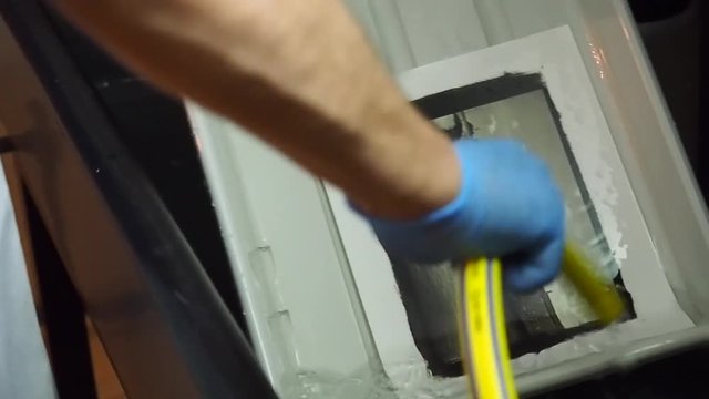man photographer working in darkroom with photographs hanging to dry