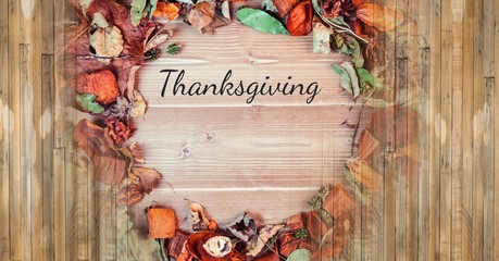 thanksgiving text with rustic Autumn leaves and wood