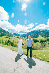Naklejka premium Young couple admires the view in relaxation of the Dolomites in italy