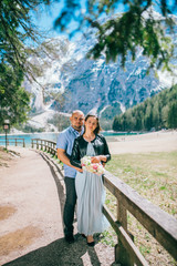 Young Couple against lake, summer park. lago di braies,Dolomite,Italy. Man and woman on vacation in beautiful place.
