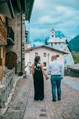 Young couple are walking on an ancient mediterranean street in italy