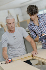 Carpenters measuring up wood