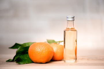 Bottle of orange oil on a wooden table