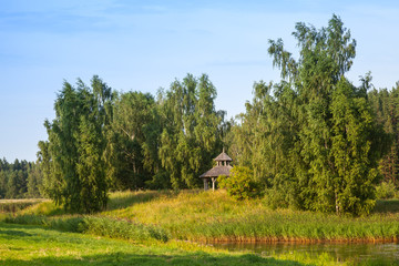 Summer landscape with wooden gazebo