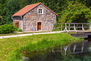 Fototapeta premium Summer landscape with old stone storage
