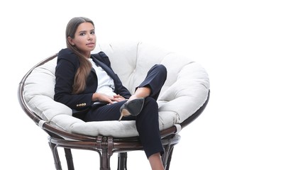 young business woman relaxes in a round chair