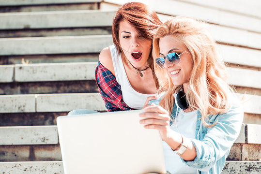 Best Friends With Computer Laptop Looking Surprised.