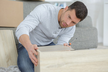 man assembling furniture