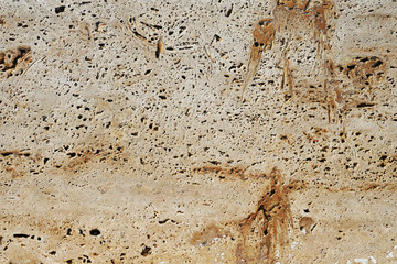 Rough texture of a porous light stone pattern background.