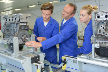 Instructor teaching apprentice engineers