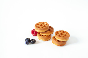 Pile of Belgian waffle with blueberry, raspberries and fresh mint Isolated