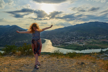 Happy young woman near Jvari Monastery of Georgia