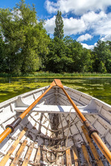 Fototapeta na wymiar Wooden Rowing boat on a lake in UK summer sun Shropshire UK