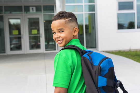 Cheerful African American Primary School Boy With Backpack