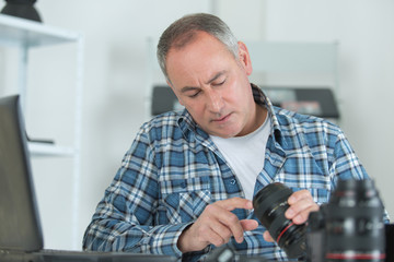 technician examining and repairing dslr camera