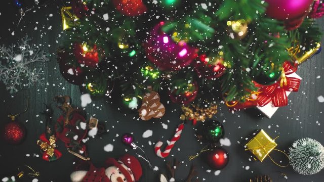 Greeting Season concept.Christmas tree and decorations with presents and ornaments on wood table from above in 4k (UHD)