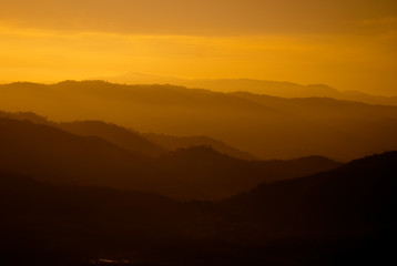Obraz premium Beautiful orange color mountain range layers during sunset.