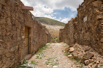stone built houses along the cobblestone streets are mostly abandoned an in ruins in Real de Catorce Mexico 