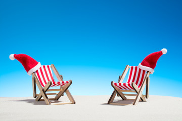 Christmas on the beach: two chairs and Santa's hats
