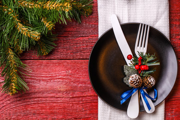 Photo of Christmas table with fork and knife on plate