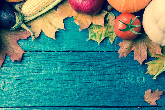 Toned image of autumn leaves, pumpkin, tomato, pomegranate,