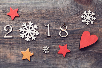 Happy New Year 2018 of real wooden figures with snowflakes and stars on wooden background.