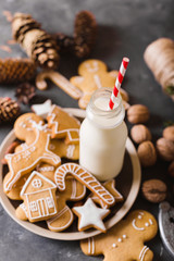 Milk and cookies. Gingerbread  cookies on a gray background.  Christmas cookies.  Ginger men