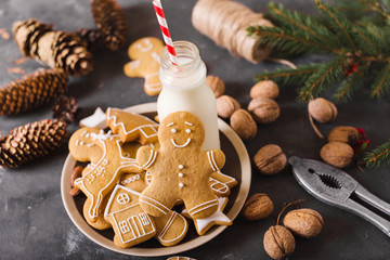 Milk and cookies. Gingerbread  cookies on a gray background.  Christmas cookies.  Ginger men
