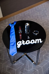 beautiful black leather shoes and other accessories of the groom on the black table