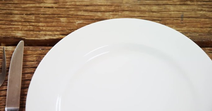 Various cutlery on wooden table 