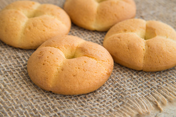 lush ruddy biscuits shot on sack, cookies on natural rustic background