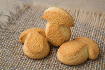 ruddy cookies on form of mushroom shot on on natural rustic background, homemade delicious