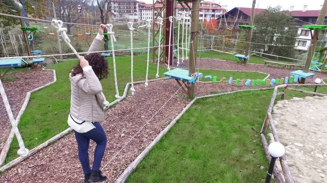 Teen passing through obstacles in a Rope Park Challenge