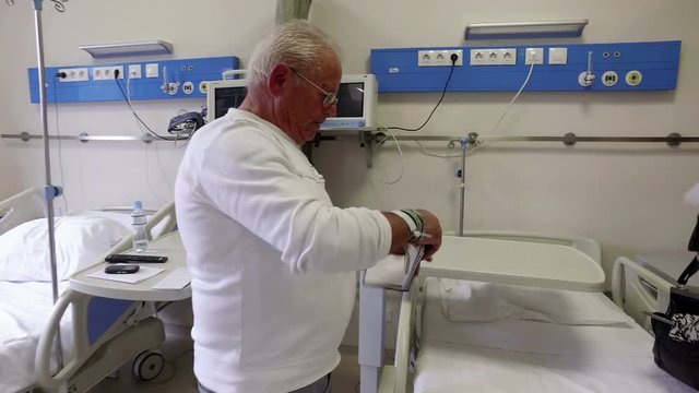 Senior patients at hospital worried holding documents before surgical operatiion