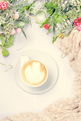 Cup of coffee or chai tea with latte art and Christmas decor. Leisure time concept. Pastel colors