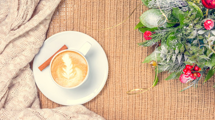 Cup of coffee or chai tea with latte art and Christmas decor. Leisure time concept. Pastel colors