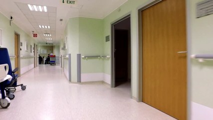 oung female patient walk in hospital corridor