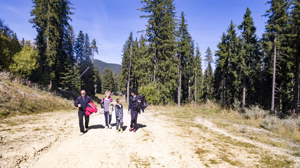 Fototapeta na wymiar Group of people walking in summer mountains