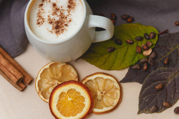Cocoa or latte or hot chocolate with cinnamon. On a bright wooden background.