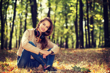 Young  girl smiling in autumn scenery.