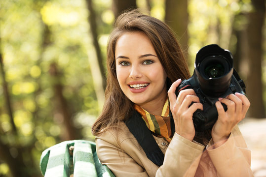 woman is a professional photographer with photo camera
