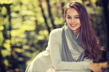 Beautiful  girl in stylish fashion clothes in autumn Park.