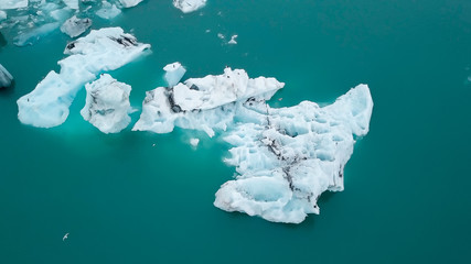 Aerial over icebergs floating in Jokulsarlon Lagoon by the southern coast of Iceland