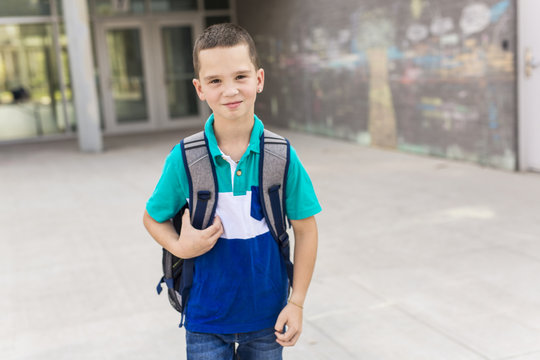 Great Portrait Of School Pupil Outside Classroom Carrying Bags