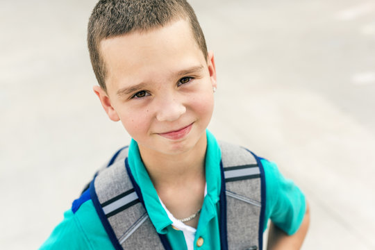 Great Portrait Of School Pupil Outside Classroom Carrying Bags