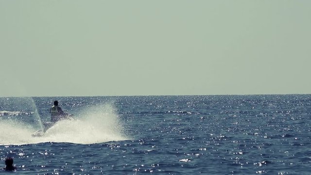 Young Man ride fast on Jet Ski, Tropical Ocean, Vacation 